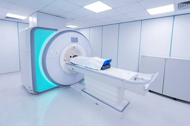 Female patient undergoing MRI - Magnetic resonance imaging in Hospital. Medical Equipment and Health Care - Photo, Image