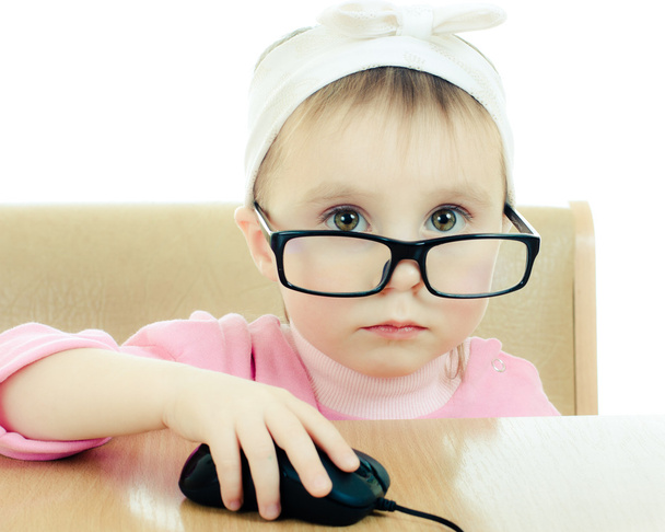 Cute baby with glasses looking into the laptop - Foto, Bild