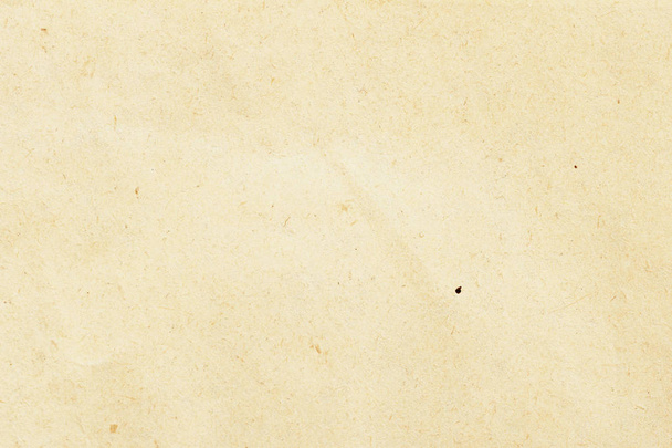Texture of ecological beige paper, background for design with copy space text or image. Recyclable material, has small inclusions of cellulose - Photo, image