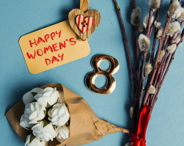 Happy International Womens Day celebrate on March 8, congratulatory CARD. rose-color paper hearts shape figure eight 8 on blue background  - Foto, Imagem