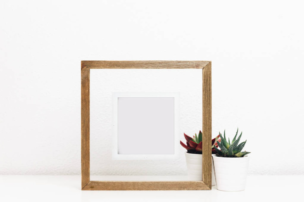 Wooden frame mock up with succulents pots. Nordic Scandinavian style home interior  - Foto, immagini