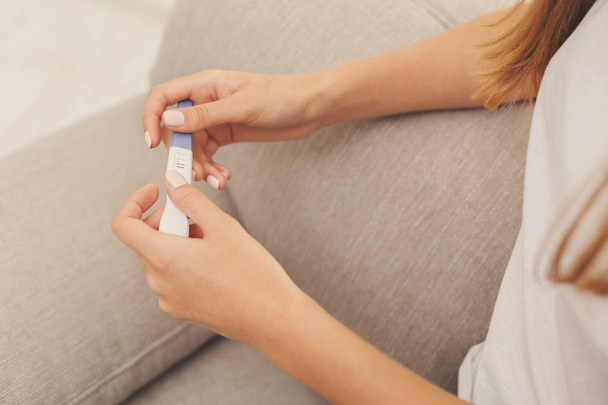 Closeup of woman hands holding a positive pregnancy test - Fotografie, Obrázek