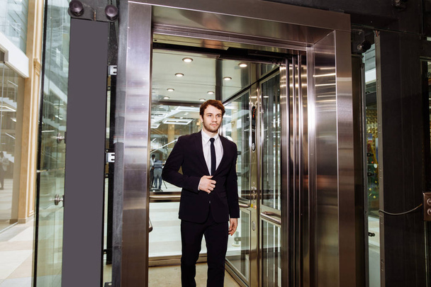 middle aged businessman with briefcase coming out from elevator - Photo, Image