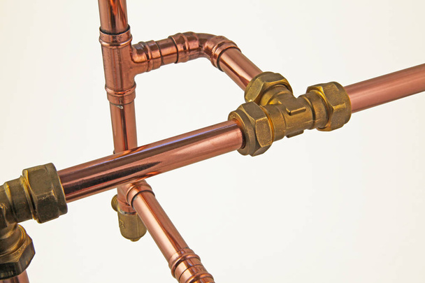 Copper pipework   Copper pipe, compression and solder fittings isolated on a white background,  - Photo, Image