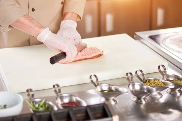 Chef processing meat on board. - Foto, immagini