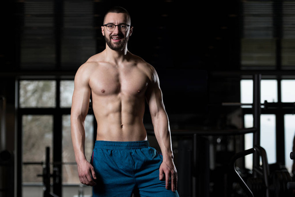 Portrait Of A Physically Fit Muscular Nerd Man - 写真・画像