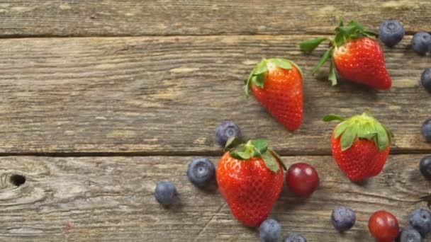 summer fruits on a wooden table. Blueberries Grape Strawberries SLOW MOTION hd video - Footage, Video