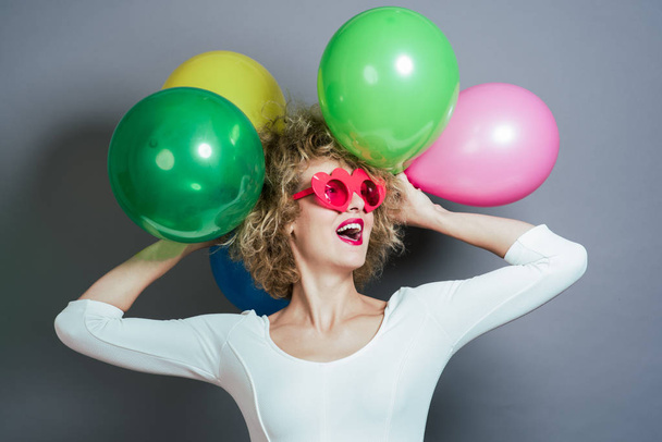 Happy funny blonde woman holding balloons - Photo, Image