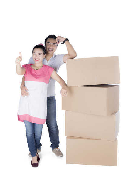 Sweet couple with stack of cardboard boxes - Zdjęcie, obraz