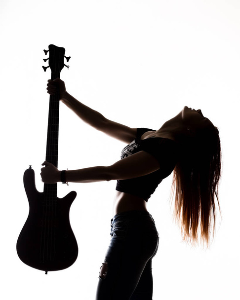 silhouette of rock woman playing on electric guitar on a white background. - Foto, Imagen