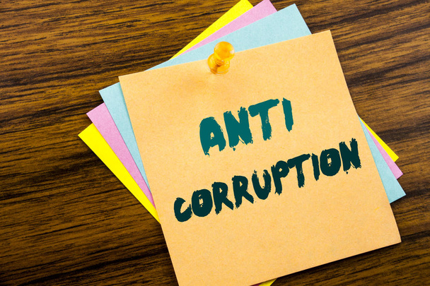 Hand writing text caption inspiration showing Anti Corruption. Business concept for Bribery Corrupt Text written on sticky note paper on the wooden background. - Photo, Image