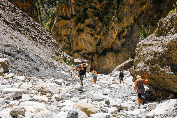 Crete, Greece, May 26, 2016: Tourists hike in Samaria Gorge in central Crete, Greece. The national park is a UNESCO Biosphere Reserve since 1981 - Photo, Image
