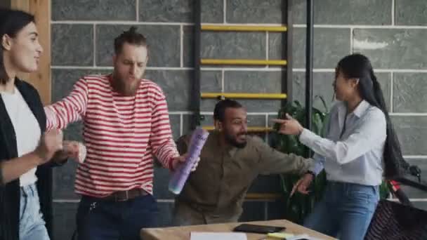Multi-ethnic start-up business colleagues have fun dancing in loft office and celebrating success of project - Footage, Video