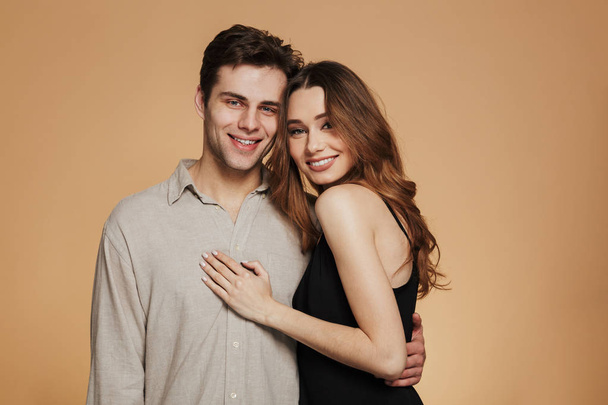 Portrait of a smiling loving couple hugging while standing - Valokuva, kuva
