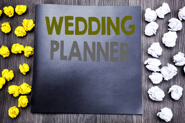Hand writing text caption inspiration showing Wedding Planner. Business concept for Marriage Preparation Written on notepad note notebook book wooden background with sticky folded yellow and white - Photo, Image