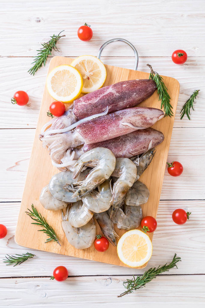 fresh seafood raw (shrimps ,squids) on wooden board  - Fotografie, Obrázek