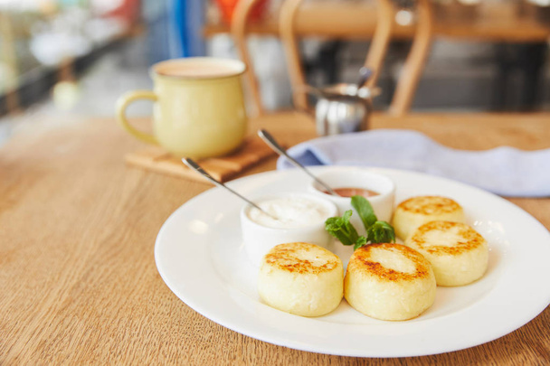 Breakfast with cheese pancakes served with coffee - Photo, Image
