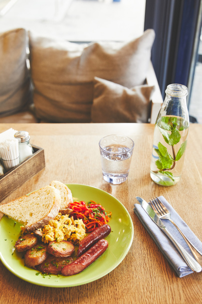 Brunch in restaurant with scramble eggs and sausage - Foto, imagen