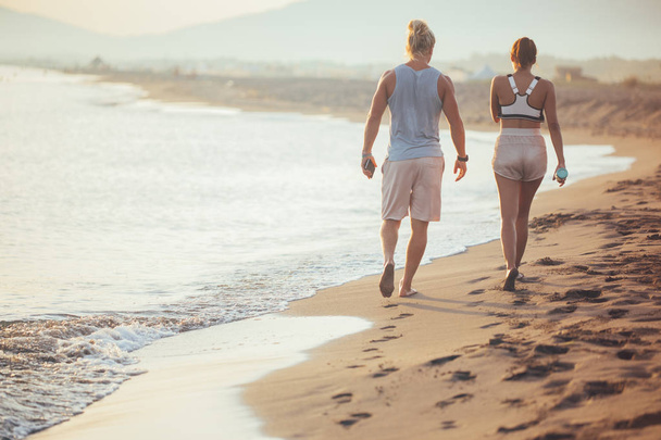 Couple Walking Together by the Sea  - Φωτογραφία, εικόνα