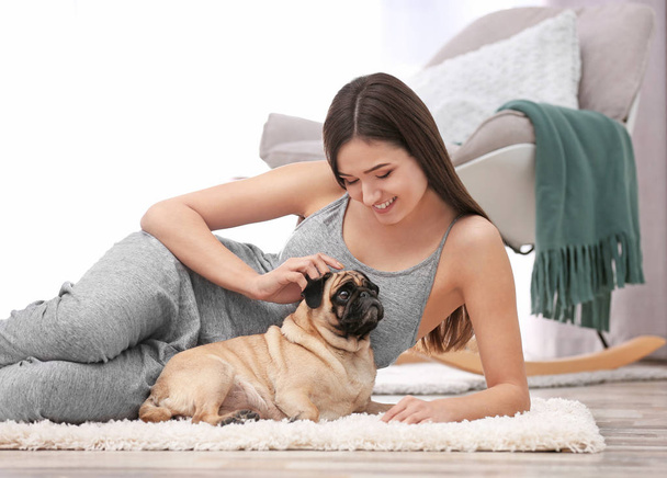 Woman with cute dog at home. Friendship between pet and owner - Zdjęcie, obraz