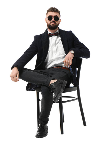 Portrait of handsome hipster in stylish outfit on white background - Fotó, kép