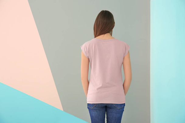 Young woman in stylish t-shirt on color background. Mockup for design - Foto, afbeelding