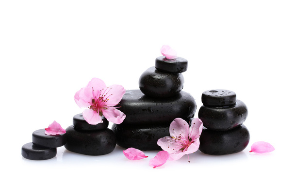 Spa stones with drops and pink sakura flowers isolated on white - Foto, immagini