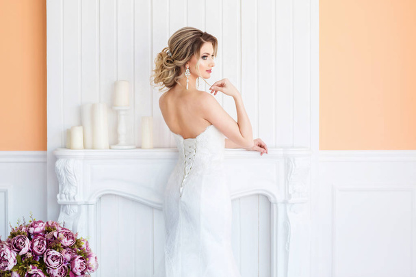 Gorgeous young woman in white wedding dress  - Fotó, kép