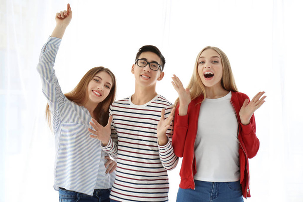 Young smiling people on white background - Φωτογραφία, εικόνα