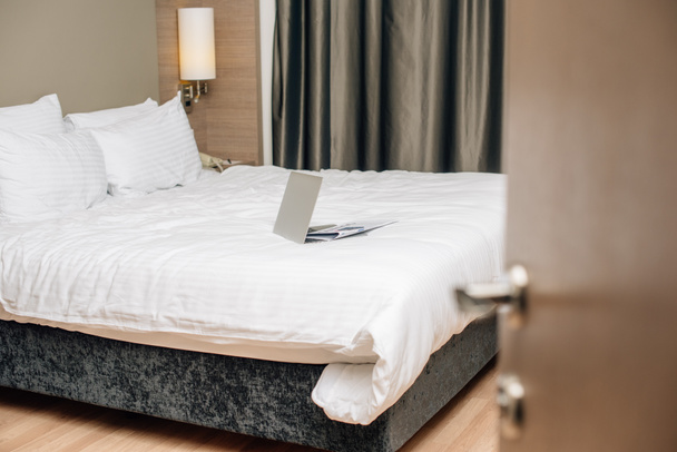 laptop on bed at modern hotel suite - Photo, Image