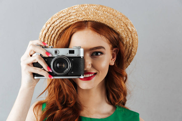 Redhead young cheerful happy lady photographer - Foto, Bild
