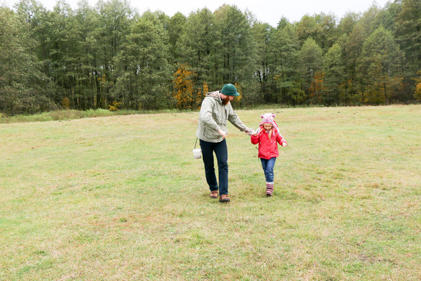 Young father playing with his daughter in a field - Valokuva, kuva