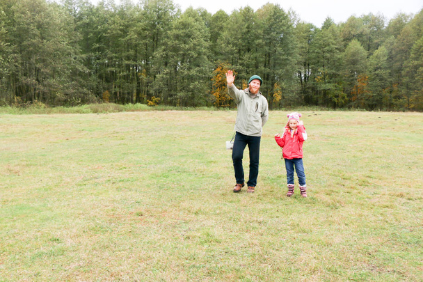 Young father playing with his daughter in a field - Photo, Image