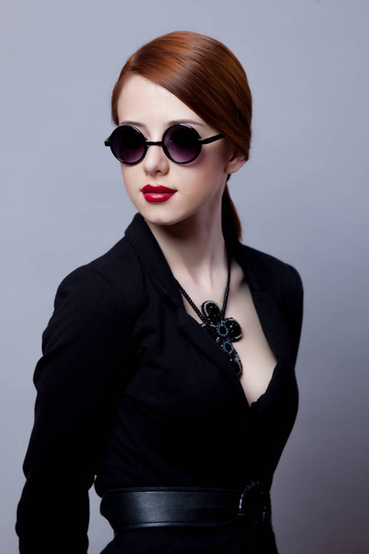 Portriat of style redhead girl in black clothes on grey background  - Foto, Imagem