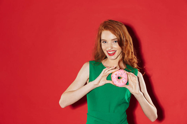 Young redhead happy girl with donut - Zdjęcie, obraz