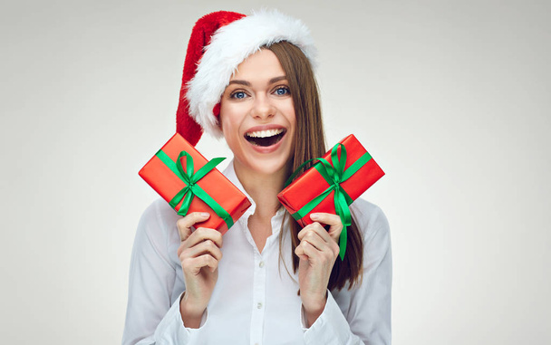 smiling businesswoman in Santa hat holding two red gifts  - Foto, afbeelding