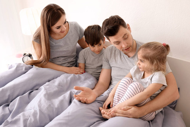 Happy family with children on bed at home - Фото, зображення