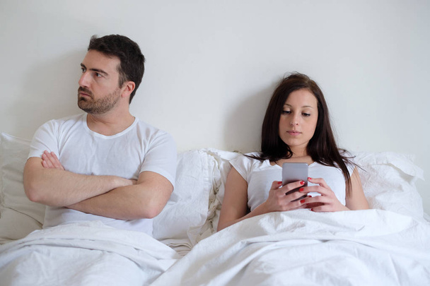Bored couple and worried man by his wife mobile phone addiction - Φωτογραφία, εικόνα