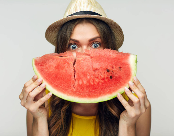 smiling woman in hat holding big slice of watermelon against face - Foto, Imagem