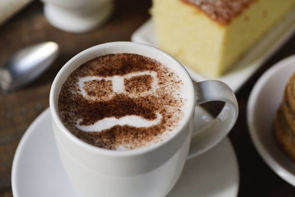 man face in a cup of cappuccino - Photo, Image