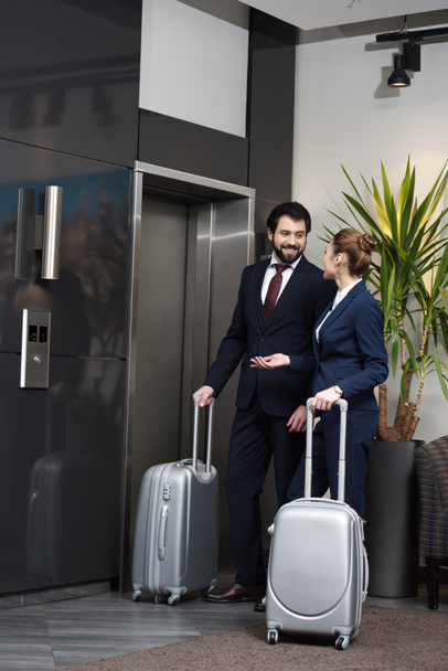 business people with luggage waiting for elevator at hotel together - Fotó, kép