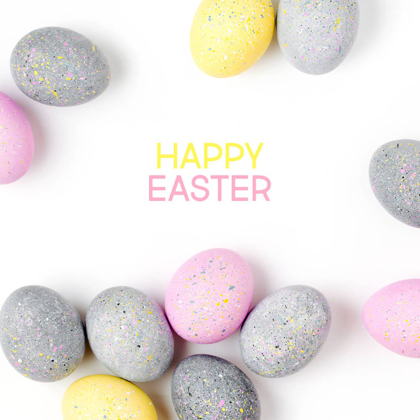 Stylish Frame of pale pink, blue and gray Easter eggs with copy space for text. Flat lay - 写真・画像