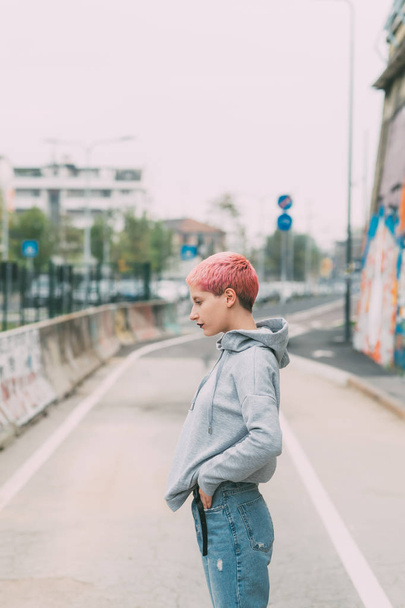 young woman pink hair outdoors posing looking away - blogger, influencer concept - Foto, Imagem