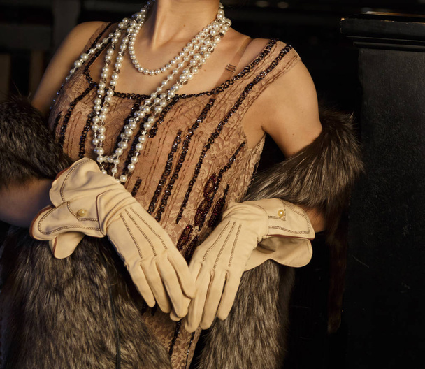 girl stands in gloves, a dress with white beads, a fur cape, a v - Photo, image