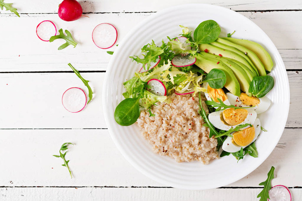 Healthy breakfast. Dietary menu. Oatmeal porridge and avocado sa - Photo, Image