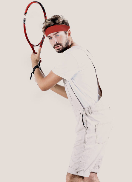 Handsome young sportsman holding racket isolated on white - Fotoğraf, Görsel