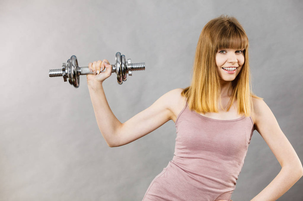 Woman working out at home with dumbbell - Foto, immagini