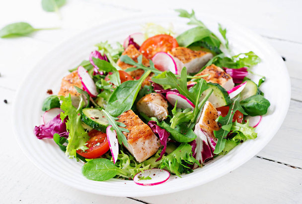 Fresh vegetable salad with grilled chicken breast   - tomatoes, cucumbers, radish and mix lettuce leaves. Chicken salad. Healthy food. - Photo, Image