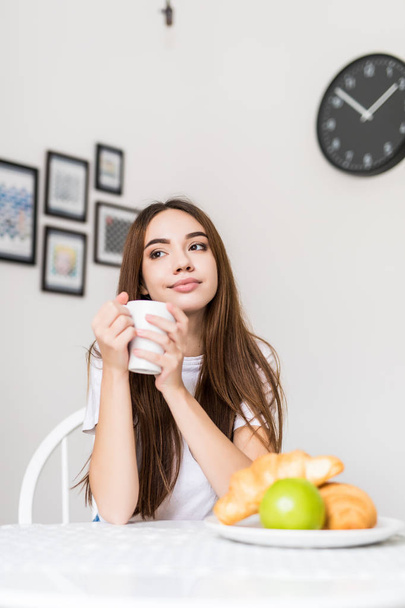 Young smiling woman eating cereal and smiling. Healthy breakfast. Starting your day. Dieting, fitness and well being. Positive energy and emotion. Productivity, happiness, enjoyment concept. - Photo, Image
