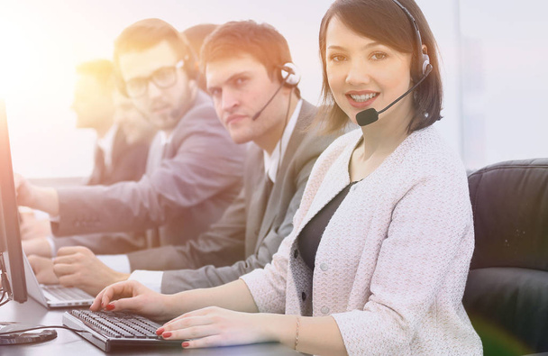 female customer service representative and colleagues in the call center - Photo, Image